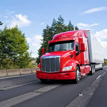 Freight Shipping from Virginia to Florida - Red semi on highway in right lane