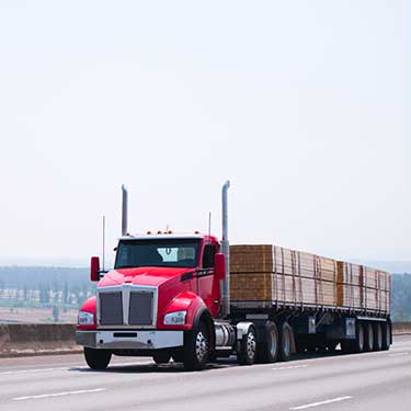 Freight Shipping from Georgia to Texas - Red flatbed on highway