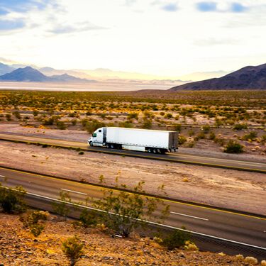 Freight Shipping from Texas to California - White truck with mountains in background