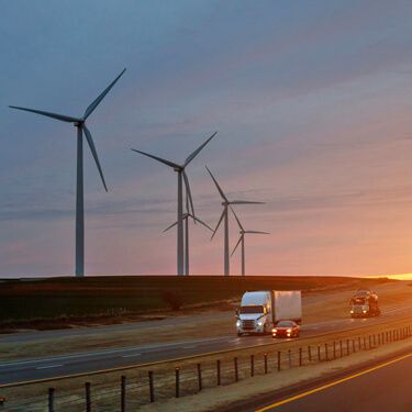 Freight Shipping from Texas to Florida - Truck driving alongside wind turbines