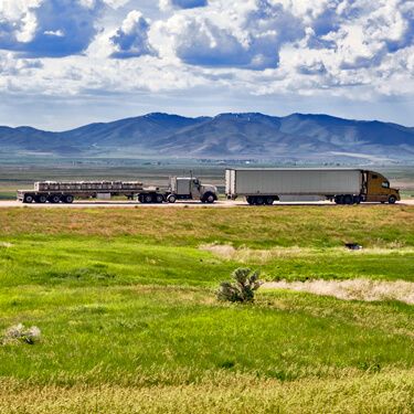 Freight Shipping from Texas to Idaho - Trucks with mountains and clouds