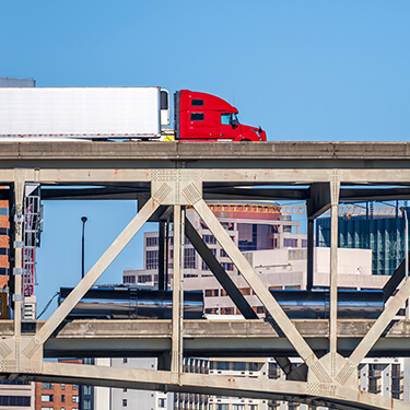 Freight Shipping from Texas to Massachusetts - Red truck on bridge