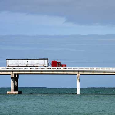 Freight Shipping from Florida to New York Truckload Traveling on Bridge in Florida