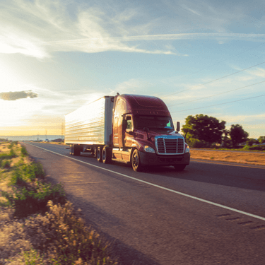 Freight Shipping from Ohio to Texas - Red truck on road with partly cloudy sky