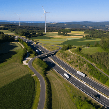 Freight Shipping from Ohio to California - Traffic along highway near wind turbines