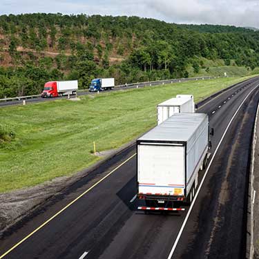 Freight Shipping from Pennsylvania to California - Trucks on highway with traffic