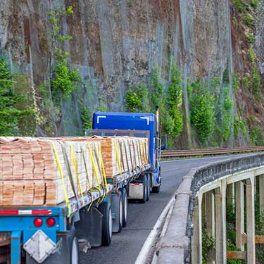 Shipping from Washington to Alaska - Flatbed on Bridge with Lumber