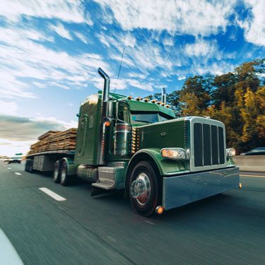 Shipping from South Carolina to California - Green flatbed truck on highway