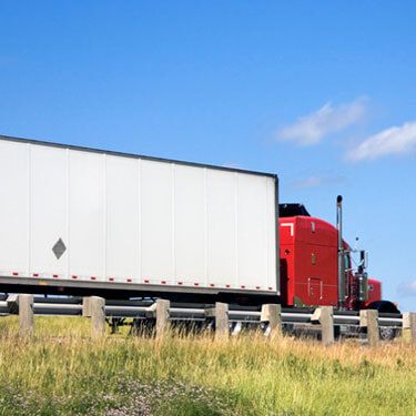 Freight Shipping from Wisconsin to Florida - Side view of red freight truck