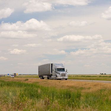 Freight Shipping from North Carolina to Texas - Truck on road with cloudy sky