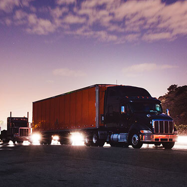 us-truckload-on-highway-at-night