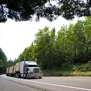 Freight Shipping from Tennessee to New York - Flatbed semi-truck on two lane highway