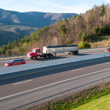 truck transporting coal on split two-lane highway