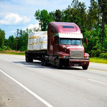 flatbed truck transporting cargo on highway