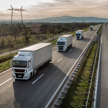 trucks driving in ordered line on highway