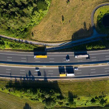 aerial overhead view of trucks on highway