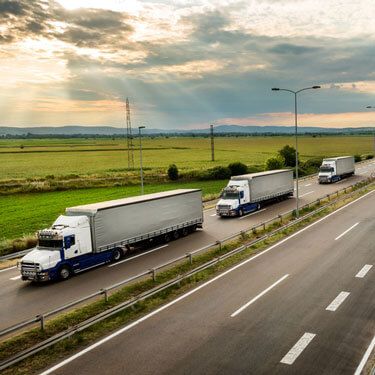 freight shipping from Iowa to New York -freight trucks in route on highway