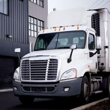 freight shipping from-Iowa to New York - truck driving through city streets