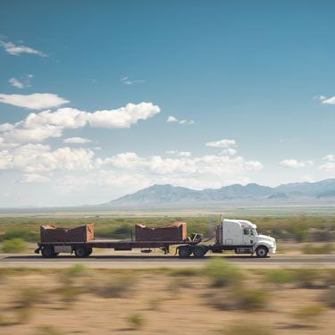 freight shipping from Kansas to Texas - truck transporting cargo on desolate highway