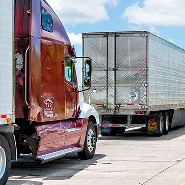 Freight Shipping from Washington DC to California - Red freight truck cab in traffic line