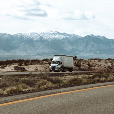 Shipping Freight from Maine to Texas - Semi truckload on highway with mountains