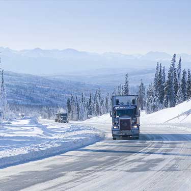 Shipping from Alaska to California - Trucks on road in winter