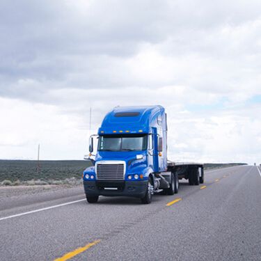 Shipping from Virginia Blue Flatbed Carrier on Highway