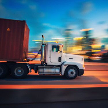 freight truck load on highway at sunset