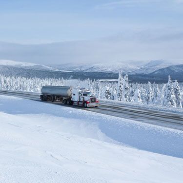 Freight Shipping from Arizona to Alaska - Freight Truck Traveling on Snow Covered Highway