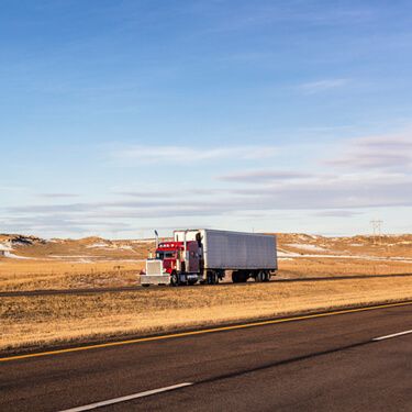 Red Semi Truckload on highway in Wyoming