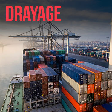 Aerial view of cargo containers stacked on a cargo shipped docked at a port