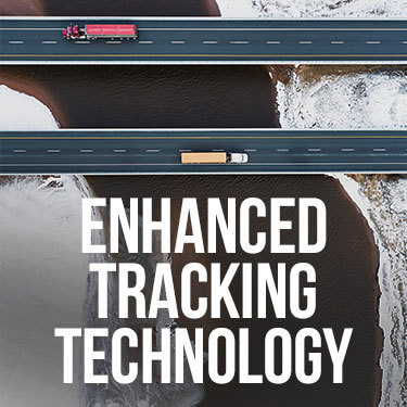 aerial view of two semi trucks with trailers moving in opposite directions on parallel highways