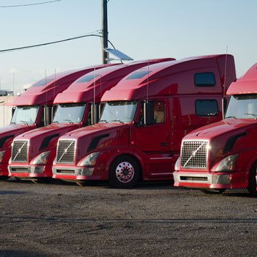 freight trucks lined up in parking lot