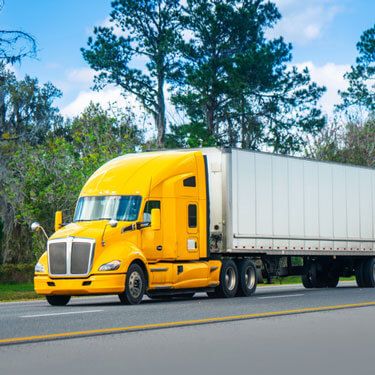 yellow freight truck on highway