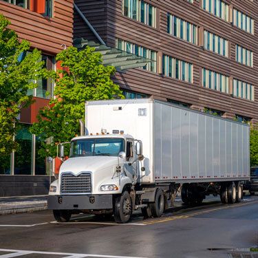 white semi-truck on city road during day