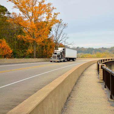 Freight Shipping from West Virginia to New York - Truck on Highway in Autumn