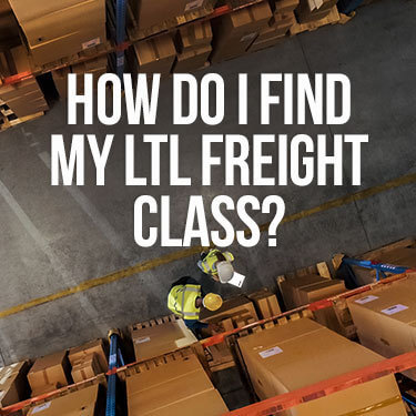 Overhead view of two workers examining a package in a warehouse aisle 