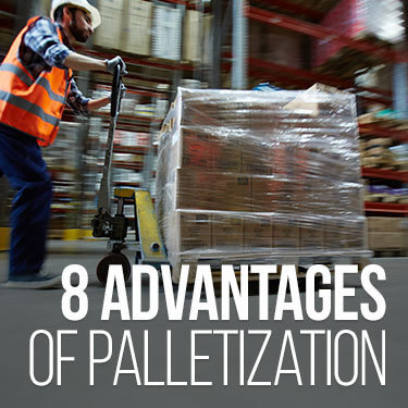 Warehouse worker moving pallets with a pallet jack inside a warehouse