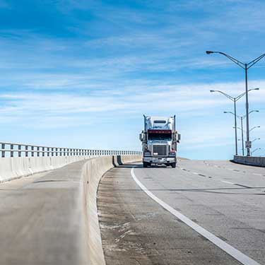 Freight Shipping from Utah to California - Truck on highway bridge in right lane