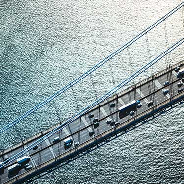 Freight Shipping from California to New York - Aerial view of trucks traveling on highway