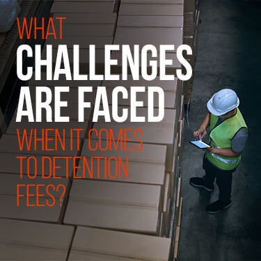 A warehouse worker looks over stacks of freight boxes