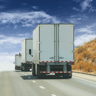 Freight Shipping from Ohio to Texas - Trucks on road with dark blue sky