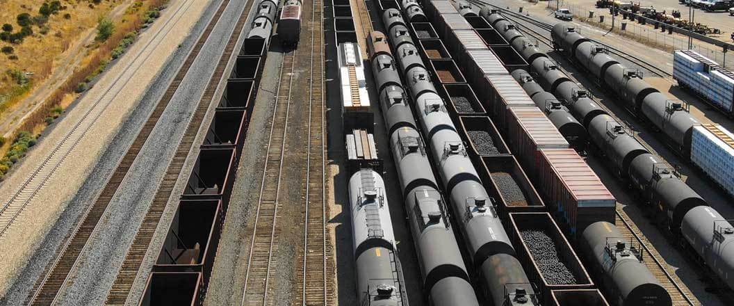 Tanker and hopper cars in a rail yard